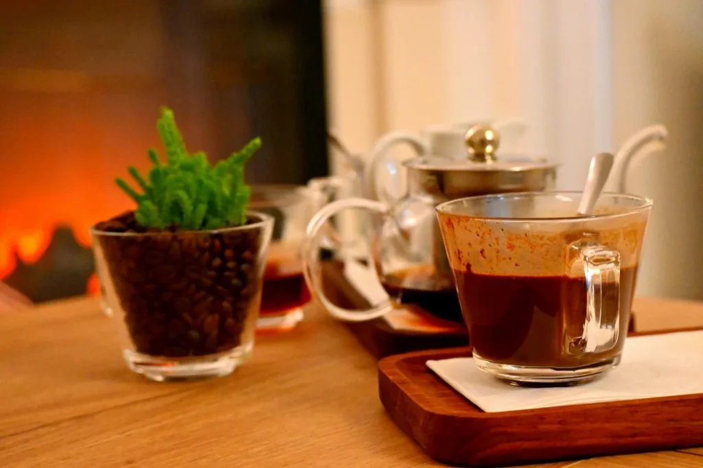 wo cups with tea and coffee, along with dessert on the table